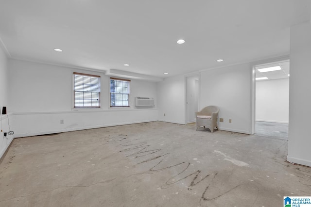 unfurnished living room featuring an AC wall unit and recessed lighting