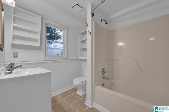 bathroom featuring toilet, tile patterned flooring, bathtub / shower combination, vanity, and baseboards