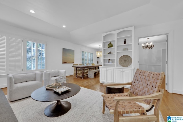 living area with a chandelier, light wood finished floors, recessed lighting, and baseboards