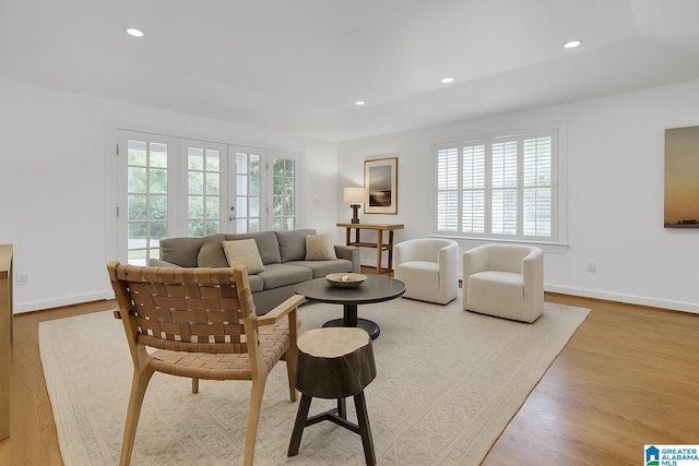 living room with healthy amount of natural light, recessed lighting, wood finished floors, and baseboards