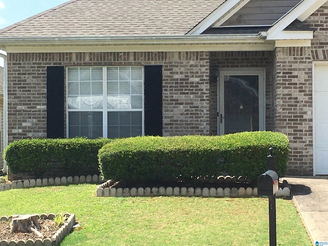 1037 Windsor Pkwy, Moody, AL 35004 - property entrance featuring a shingled roof, brick siding, and a lawn