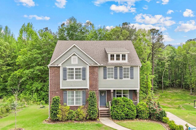 1064 Timberline Rdg, Calera, AL 35040 - view of front of house featuring roof with shingles, brick siding, and a front lawn