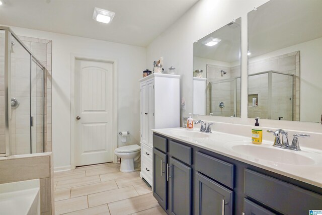1064 Timberline Rdg, Calera, AL 35040 - full bathroom featuring a stall shower, toilet, double vanity, and a sink
