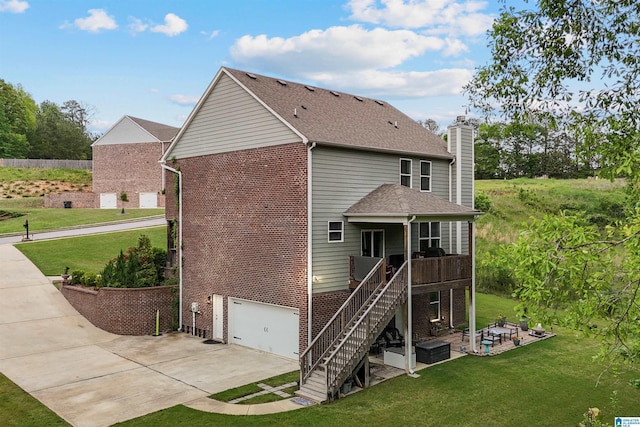 1064 Timberline Rdg, Calera, AL 35040 - back of property featuring stairs, brick siding, concrete driveway, a chimney, and a lawn