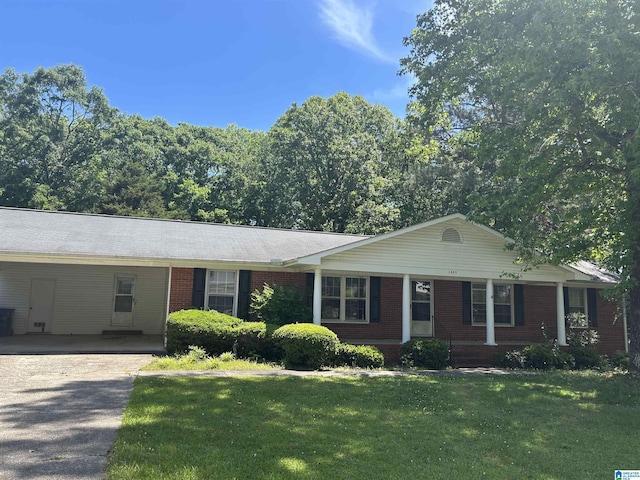 ranch-style house featuring aphalt driveway, a carport, a front lawn, and brick siding