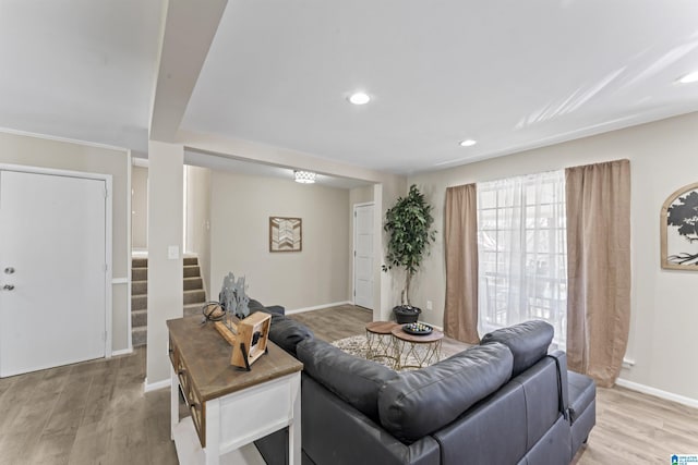 living room with baseboards, stairs, light wood-style floors, and recessed lighting