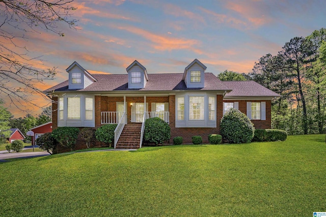 205 Beaver Ridge Cir, Ashville, AL 35953 - new england style home featuring brick siding, a yard, and a porch