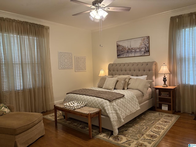 bedroom featuring ornamental molding, wood finished floors, and a ceiling fan