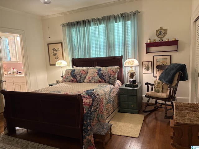 bedroom featuring multiple windows, ensuite bath, hardwood / wood-style floors, and crown molding