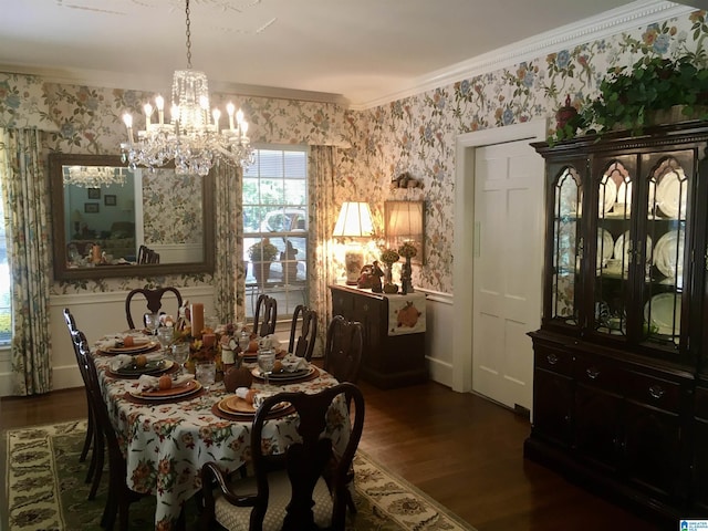 dining room with wallpapered walls, ornamental molding, wood finished floors, a chandelier, and baseboards