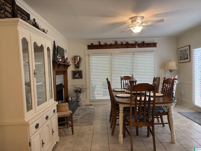 dining space featuring a ceiling fan, ornamental molding, and light tile patterned floors
