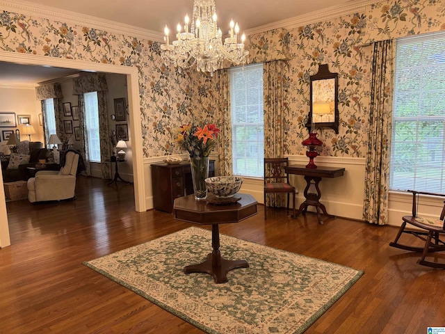 interior space featuring an inviting chandelier, wood finished floors, and ornamental molding