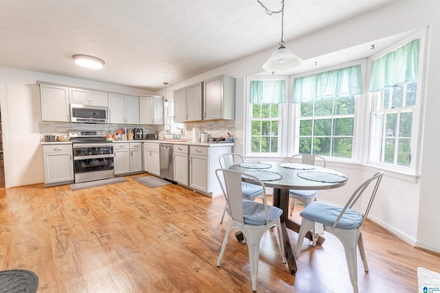 1111 Creek Trl, Anniston, AL 36206 - kitchen featuring light countertops, stainless steel appliances, tasteful backsplash, and a healthy amount of sunlight