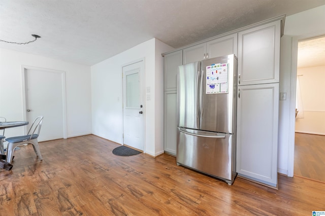 1111 Creek Trl, Anniston, AL 36206 - kitchen featuring freestanding refrigerator, gray cabinetry, baseboards, and wood finished floors