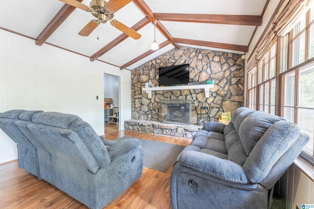 1111 Creek Trl, Anniston, AL 36206 - living area with a stone fireplace, ceiling fan, vaulted ceiling with beams, and wood finished floors