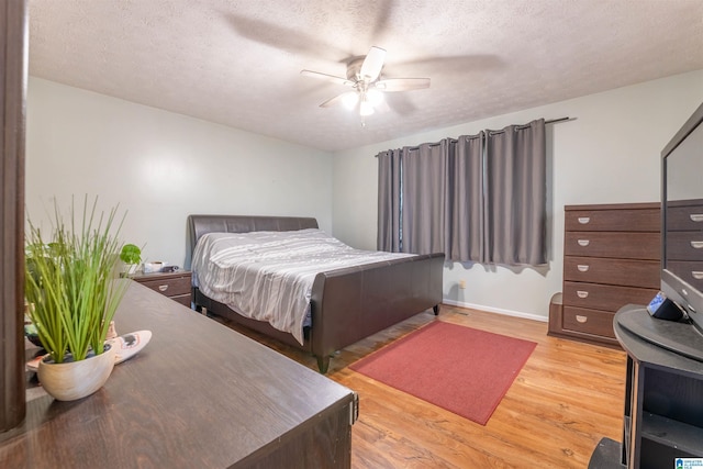 1111 Creek Trl, Anniston, AL 36206 - bedroom with baseboards, light wood-style flooring, ceiling fan, and a textured ceiling