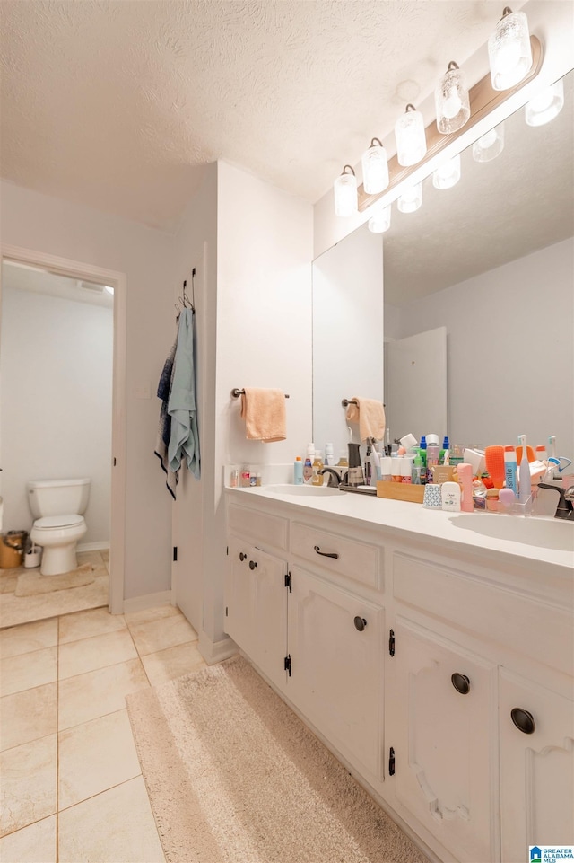 1111 Creek Trl, Anniston, AL 36206 - full bathroom with a sink, double vanity, toilet, and a textured ceiling