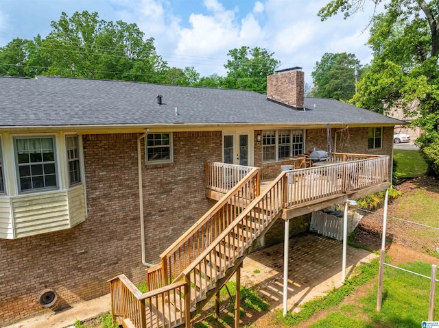 1111 Creek Trl, Anniston, AL 36206 - rear view of property with a wooden deck, a shingled roof, a chimney, and brick siding