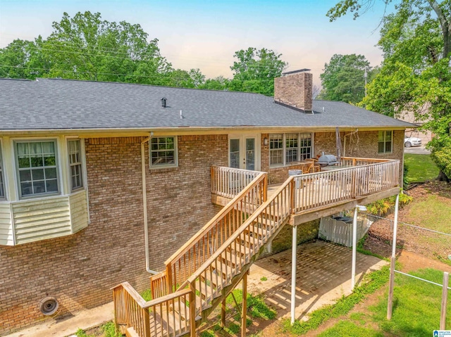 1111 Creek Trl, Anniston, AL 36206 - back of property with brick siding, a wooden deck, french doors, and a chimney