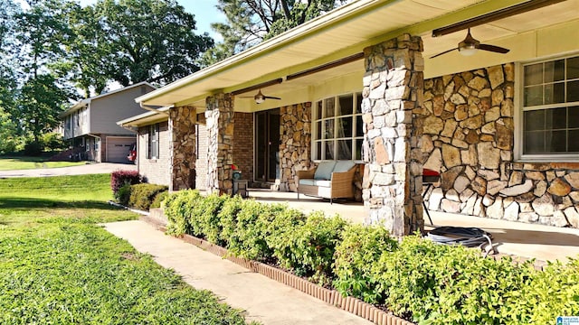 1111 Creek Trl, Anniston, AL 36206 - exterior space featuring covered porch, stone siding, ceiling fan, and a lawn