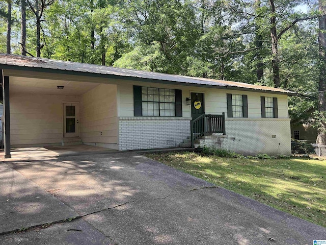 816 8th Cir N, Pell City, AL 35125 - view of front of property with brick siding, driveway, an attached carport, and metal roof