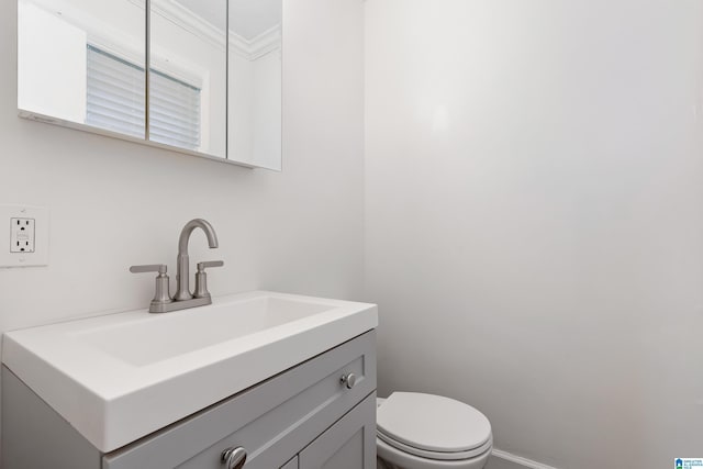 816 8th Cir N, Pell City, AL 35125 - bathroom featuring ornamental molding, toilet, vanity, and baseboards