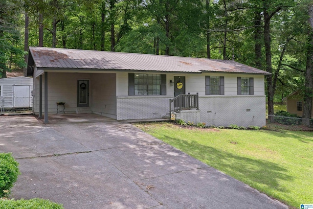 816 8th Cir N, Pell City, AL 35125 - ranch-style house featuring brick siding, metal roof, concrete driveway, an attached carport, and a storage shed