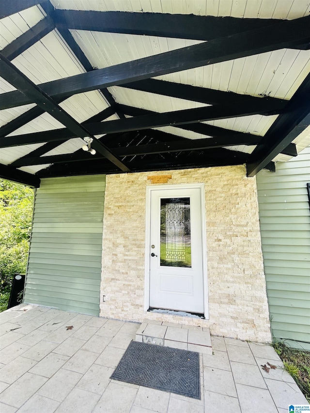 doorway to property with brick siding