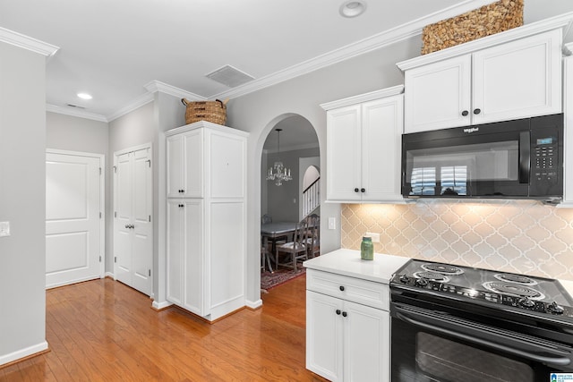 kitchen with black appliances, arched walkways, light wood finished floors, white cabinetry, and crown molding