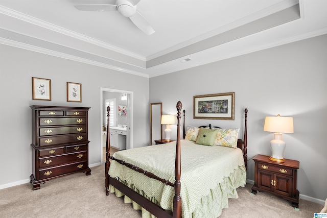 bedroom featuring light colored carpet, ornamental molding, ensuite bath, a ceiling fan, and baseboards