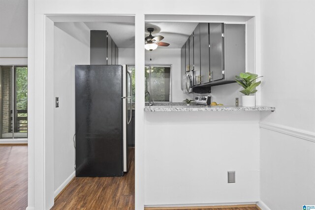 kitchen featuring stainless steel appliances, ceiling fan, dark wood-style floors, baseboards, and gray cabinetry