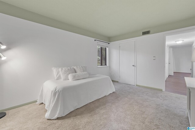 bedroom featuring carpet and baseboards