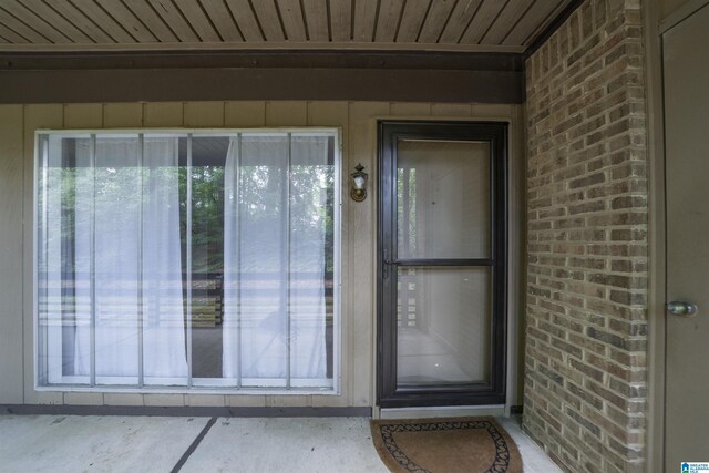 view of exterior entry with brick siding