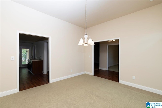 1004 Hidden Forest Dr, Montevallo, AL 35115 - empty room featuring a chandelier, baseboards, and dark carpet
