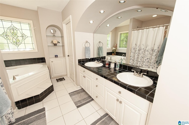 full bathroom with recessed lighting, a bath, tile patterned flooring, and a sink