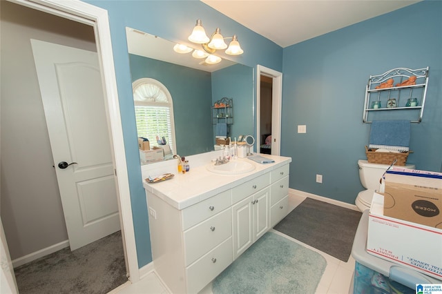 bathroom with toilet, a notable chandelier, baseboards, and vanity