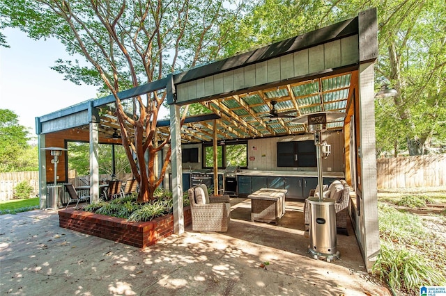 view of patio with fence and a ceiling fan