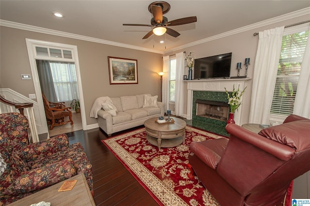 living room featuring ornamental molding, recessed lighting, ceiling fan, dark wood-style floors, and a premium fireplace