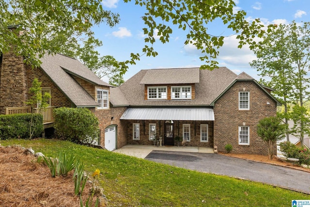 825 Dogwood Ln, Ashville, AL 35953 - view of front of house with driveway, brick siding, covered porch, roof with shingles, and a front lawn