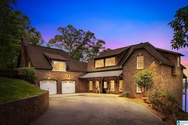 825 Dogwood Ln, Ashville, AL 35953 - view of front facade featuring a chimney, brick siding, aphalt driveway, and an attached garage