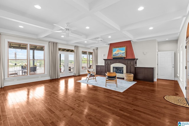 825 Dogwood Ln, Ashville, AL 35953 - living room featuring coffered ceiling, wood finished floors, a ceiling fan, and a glass covered fireplace
