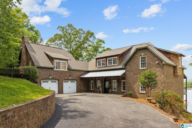 825 Dogwood Ln, Ashville, AL 35953 - view of front of house featuring a chimney, driveway, brick siding, a garage, and a front yard