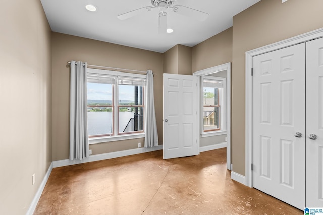 825 Dogwood Ln, Ashville, AL 35953 - unfurnished bedroom with a closet, baseboards, finished concrete flooring, ceiling fan, and a water view