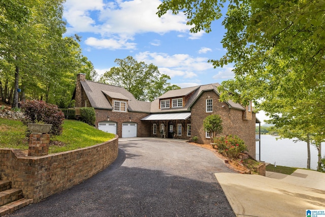 825 Dogwood Ln, Ashville, AL 35953 - view of front of home featuring roof with shingles, brick siding, aphalt driveway, and an attached garage