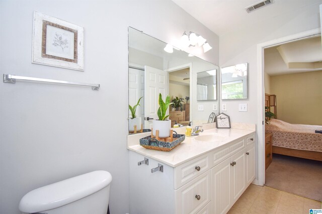 bathroom featuring toilet, tile patterned flooring, ensuite bathroom, and vanity