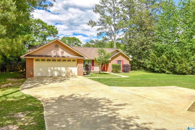 ranch-style home with brick siding, concrete driveway, and a garage