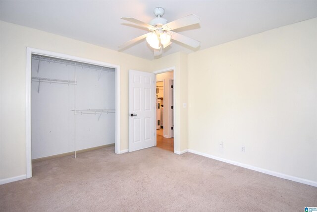 unfurnished bedroom featuring carpet flooring, baseboards, a closet, and a ceiling fan