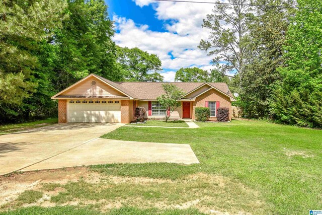 single story home with an attached garage, brick siding, concrete driveway, and a front lawn