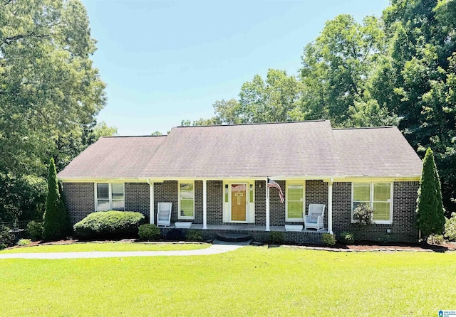 3043 Hunters Run, Gardendale, AL 35071 - cape cod home with brick siding, covered porch, a front yard, and roof with shingles