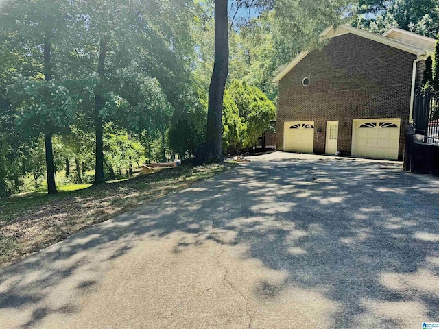 3043 Hunters Run, Gardendale, AL 35071 - view of property exterior featuring driveway, a garage, and brick siding